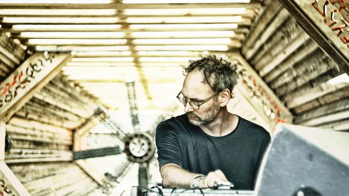 Sofus Forsberg at the controls under a wooden pavilion roof