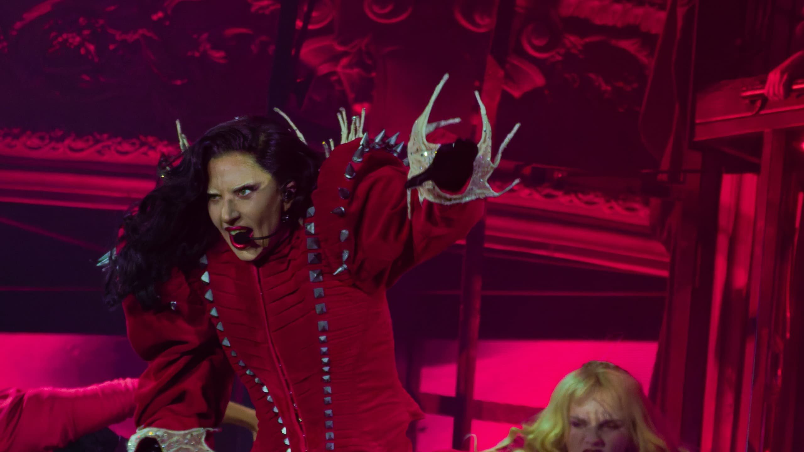 Lady Gaga in een rood kostuum zingt “Abracadabra” op het podium van haar tour The Mayhem Ball in Melbourne